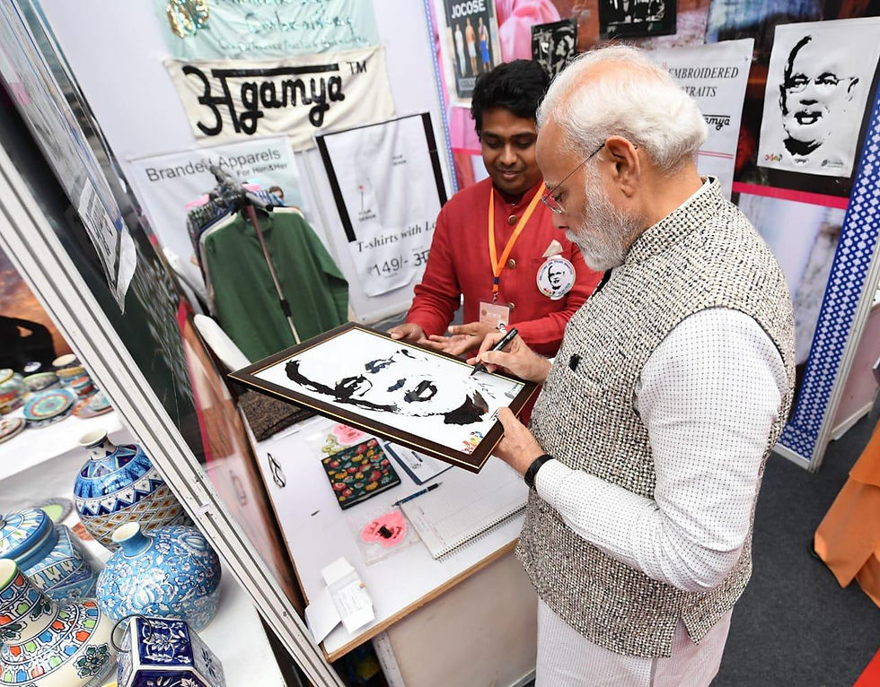 Hon'bl Prime Minister Of India, Shri Narendra Modi Ji giving autograph on his embroidered portrait.