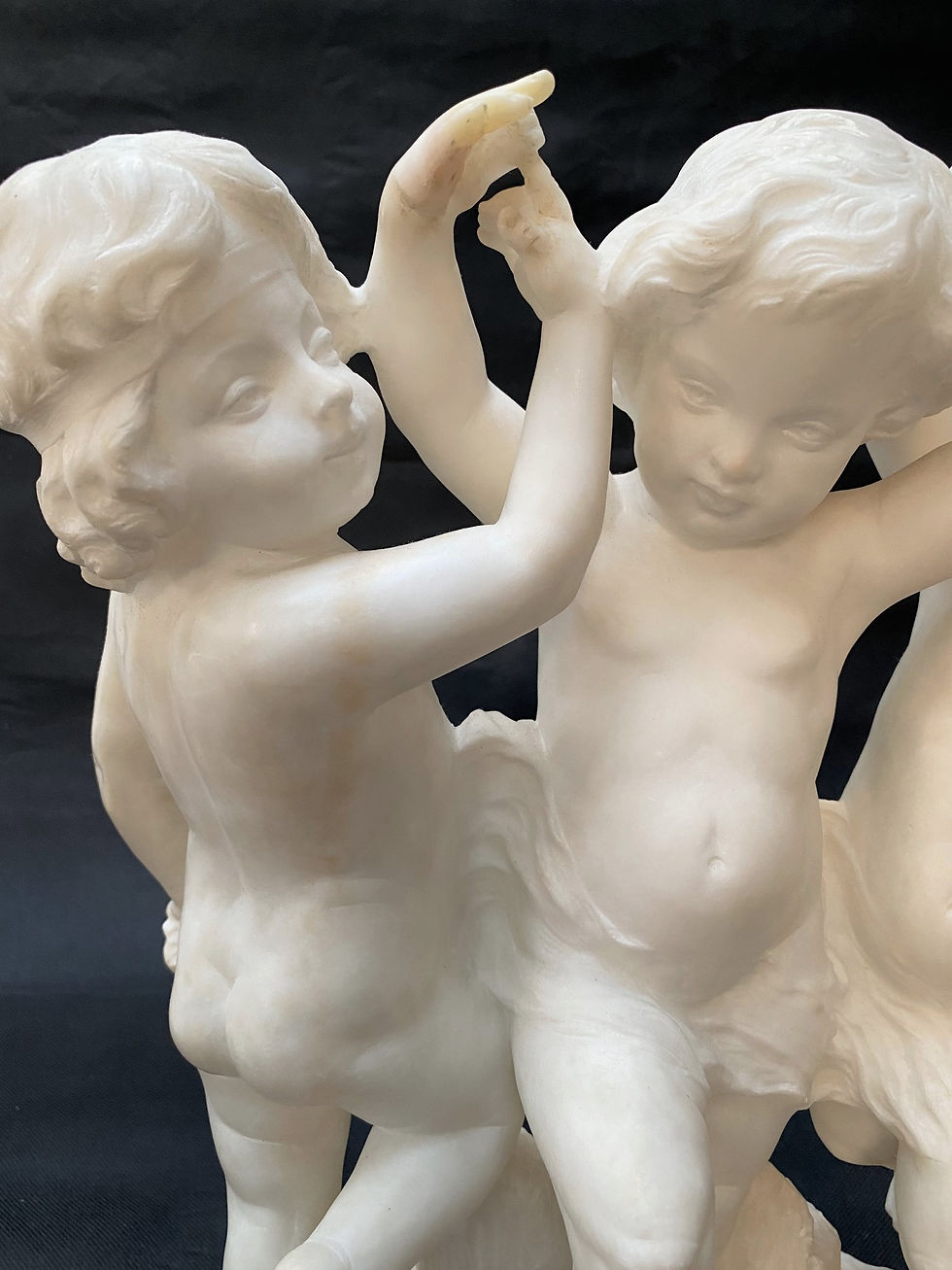Thumbnail: PUGI (Italian, 1850-1915): A carved alabaster figural group of three cherubs