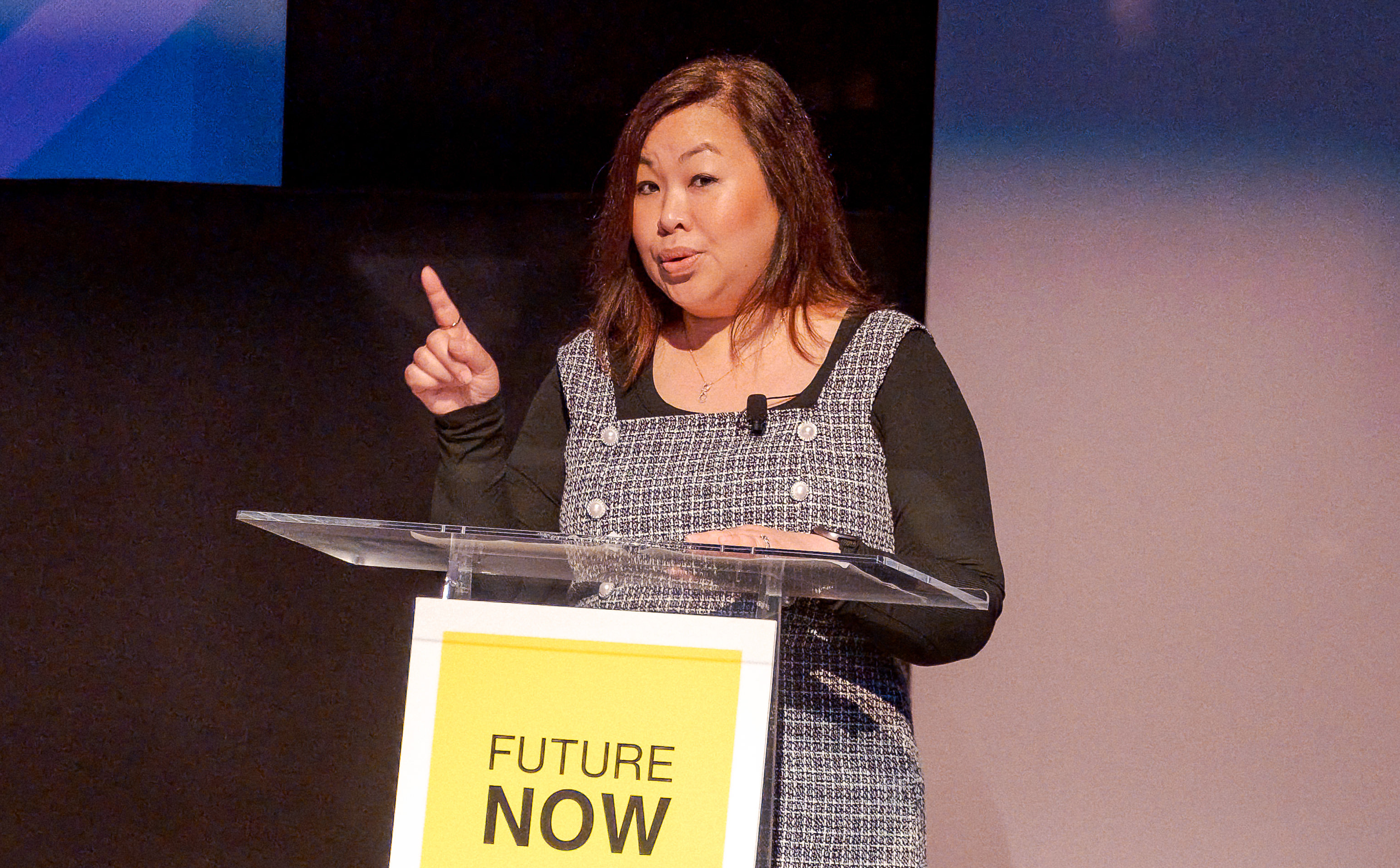 Thavary Krouch, NYC MOME, giving a keynote speech at the podium