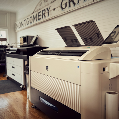 Photo of wide-format plotters at a reprographics company