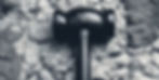 a mallet with a black handle that crackled a grey rock_edited_edited.jpg