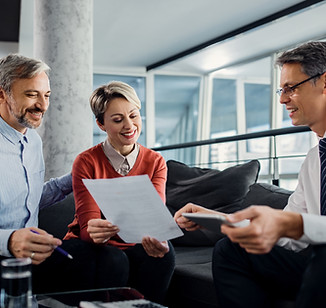 happy-couple-financial-advisor-going-through-plans-meeting.jpg