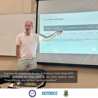 Professor Sémir Badir aponta para slide projetado em sala de aula, no curso Pragmática de atos de fala e gestos discursivos