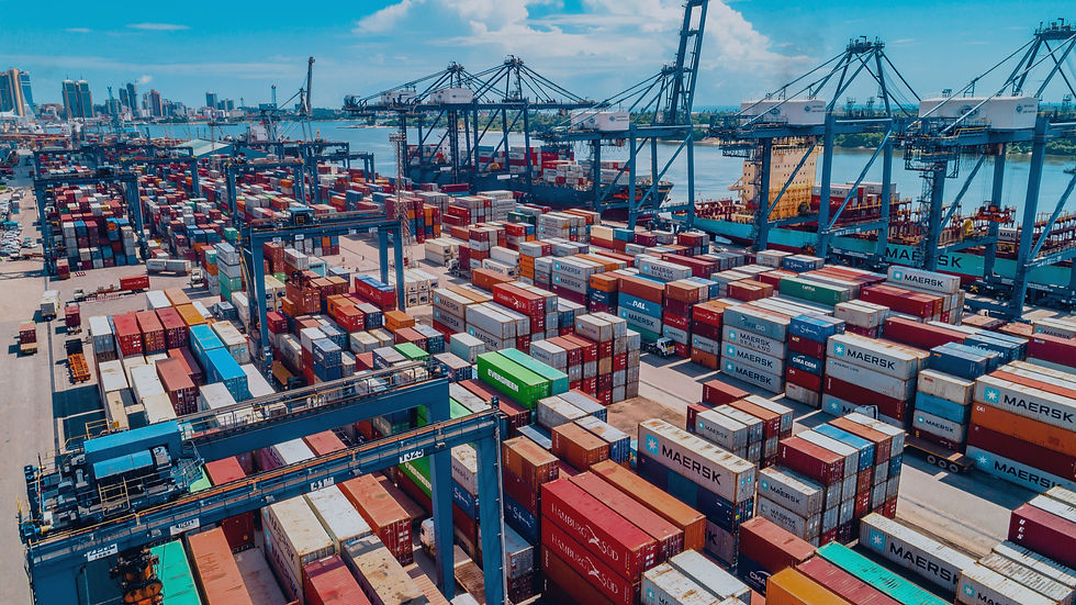Aerial view of a congested container terminal with stacked containers and cranes — demurrage and detention fees 2026