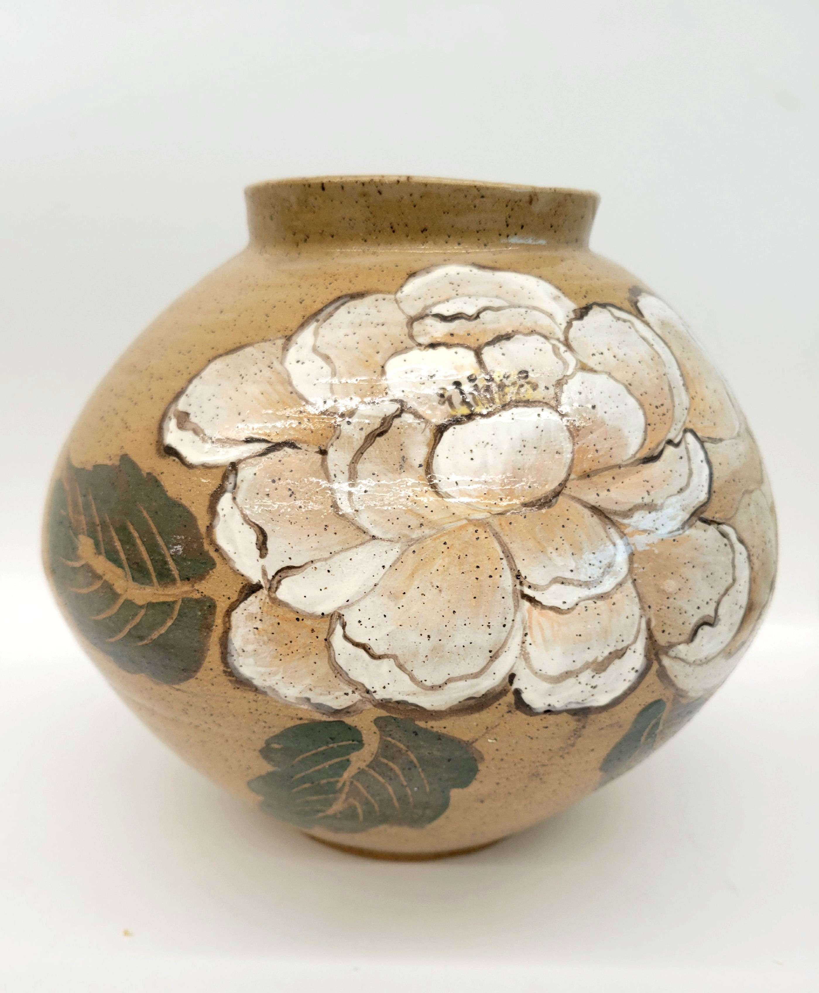 A moon jar decorated with white peony flower