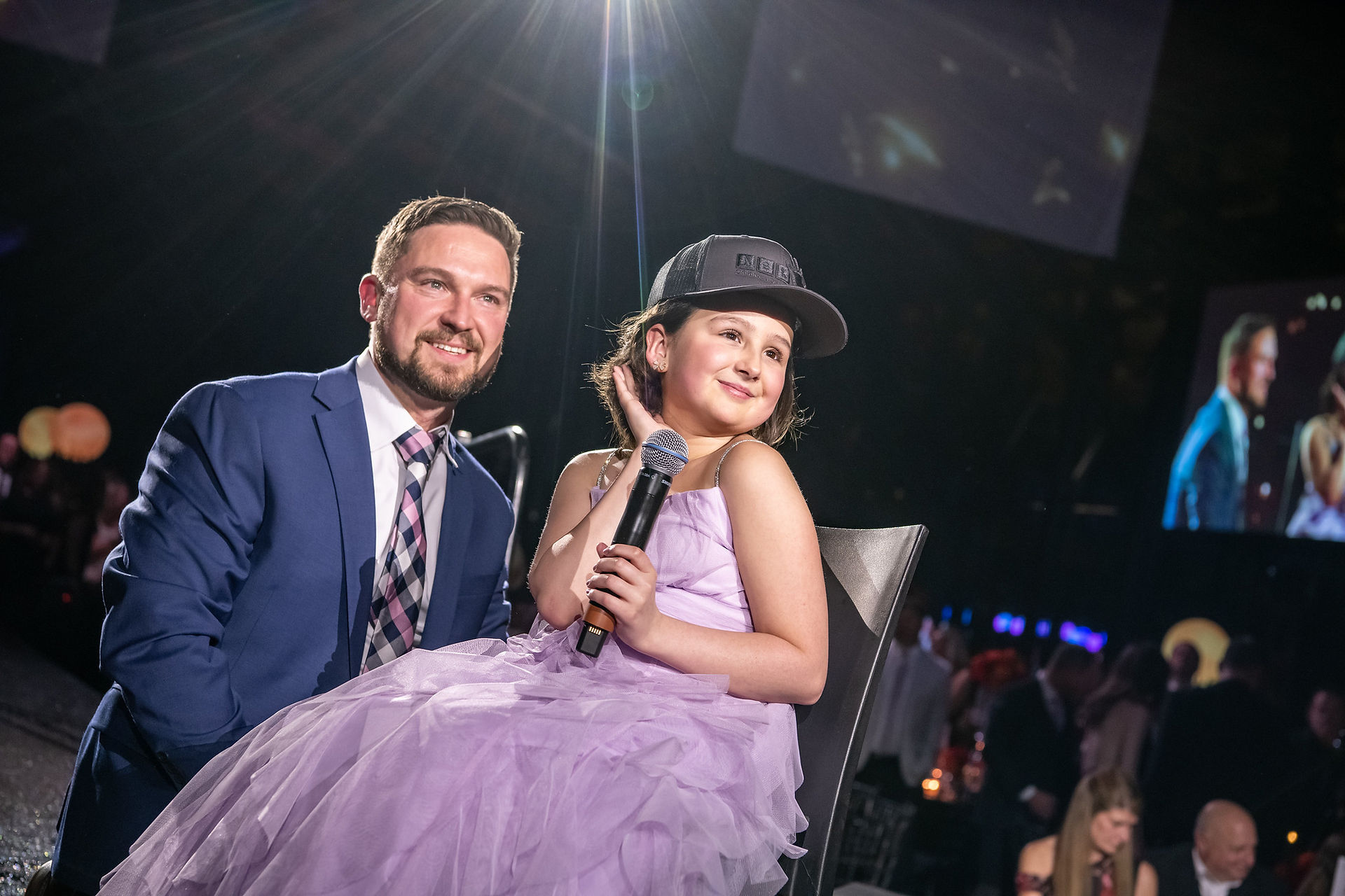 Ava on stage with her dad at the ASK Gala 2026