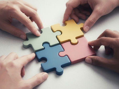Hands putting puzzle pieces together, symbolizing an integrative complex trauma treatment framework.