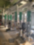 Roberts HVAC pipefitters welding and installing high-pressure piping systems in a commercial mechanical room, with coordinated supports and precision alignment.