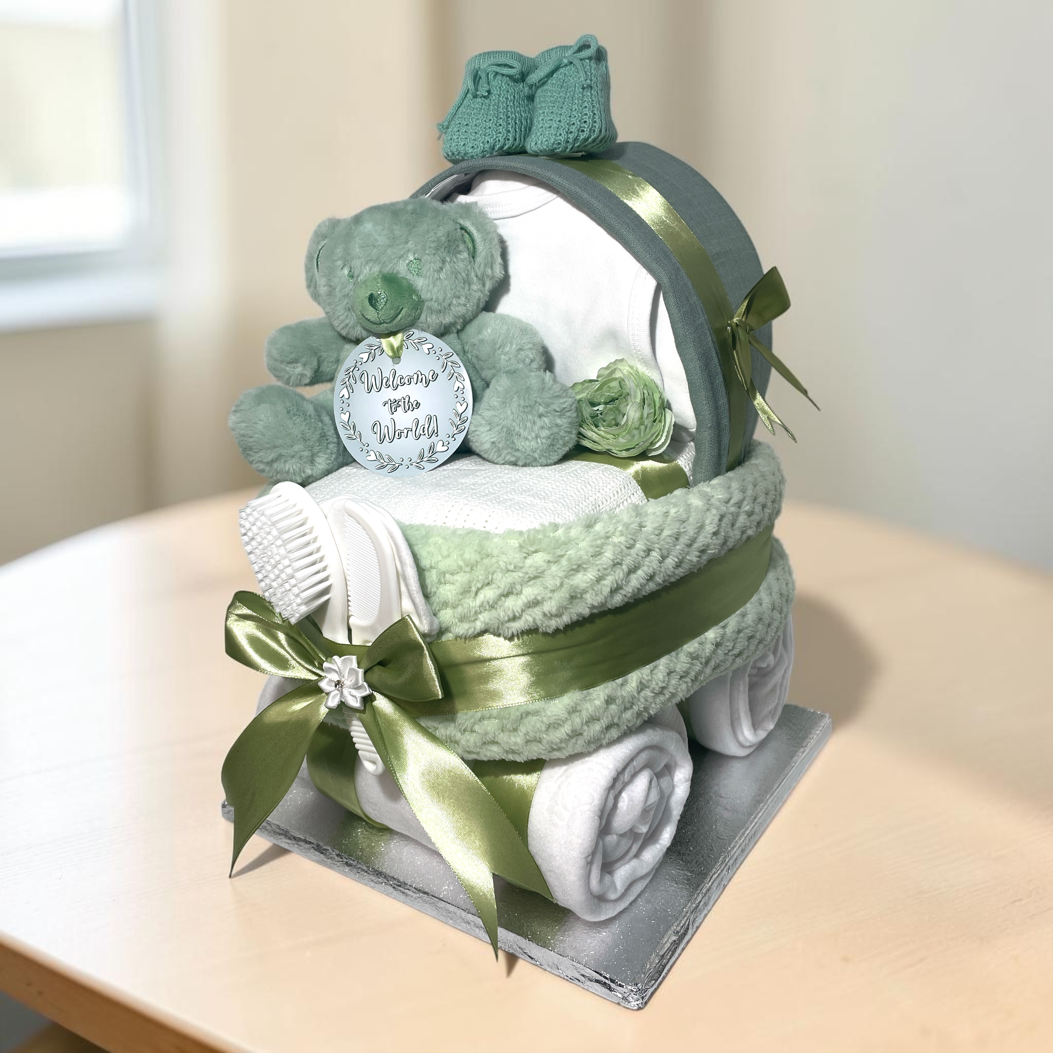 Neutral baby sage green nappy cake pram gift in sage and white tones