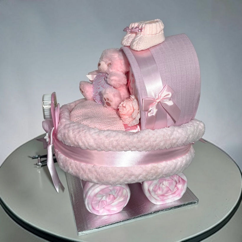 Baby girl pink nappy cake pram gift with coordinated essentials