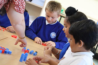 Teacher and students learning with colorful blocks