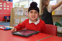 Young child with tablet for remote learning