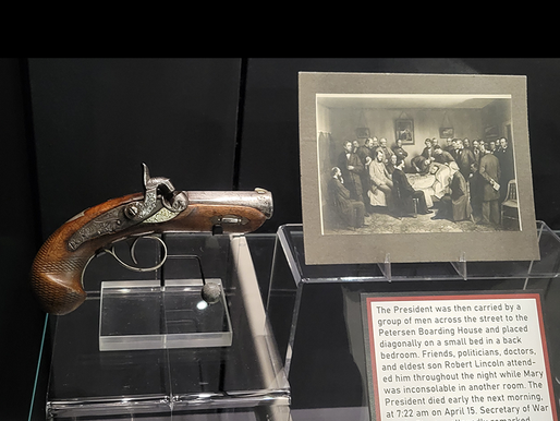 display case holding a Philadelphia Deringer .41 Pistol and bullet and painting of assassination of Abraham Lincoln.