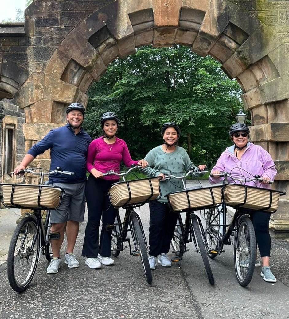 A family from North America taking a break during their bike tour within the grounds of University of Glasgow