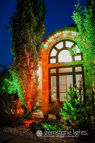 Gemstone floodlights shining on house