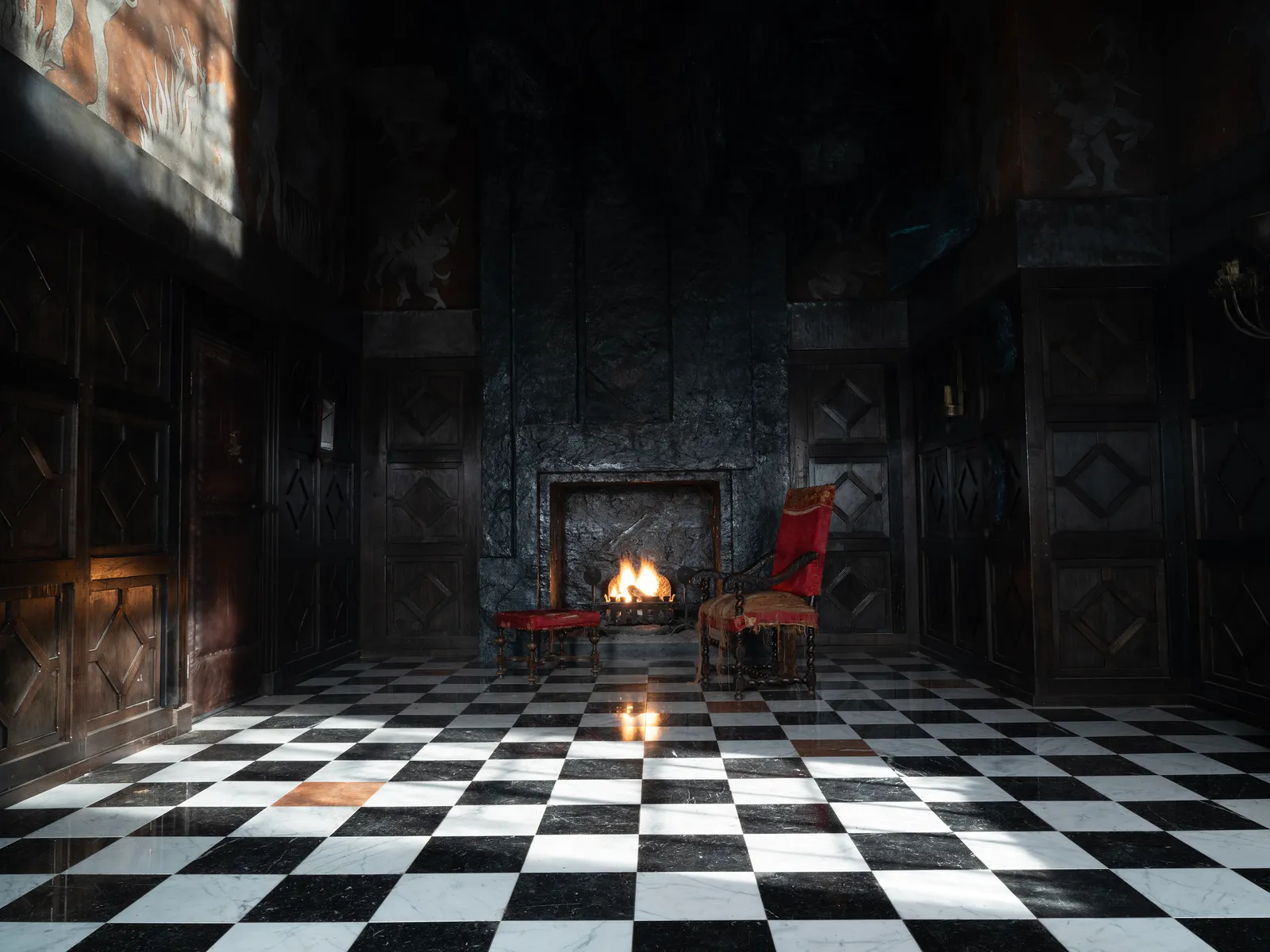 a chair and side table in front of a fireplace in a large hall