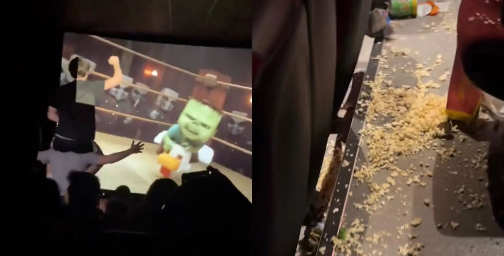 Two people in a cinema, one on another's shoulders, watching a cartoon fight. Popcorn scattered on the floor beside empty seats.