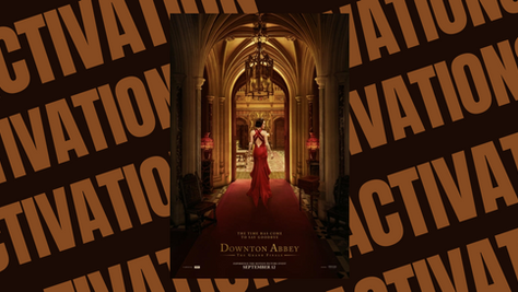 Elegant woman in red gown stands in opulent arched hall. "Downton Abbey" text below, indicating movie release on September 12.