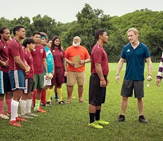 A soccer team gathered around their coach