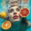 woman looking up from under water with bubbles, lemons and grapefruit.jpg