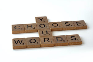 Scrabble letters spelling "Choose Your Words." Photo by Brett Jordan on Unsplash.