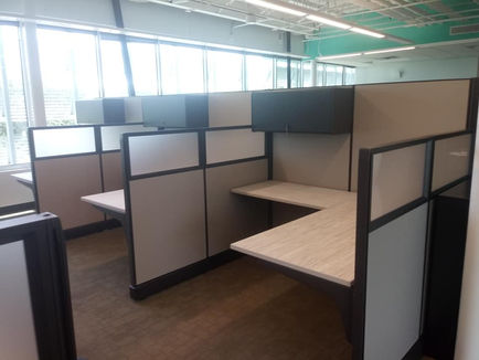 Modern office cubicles with neutral tones and ample desk space for employees