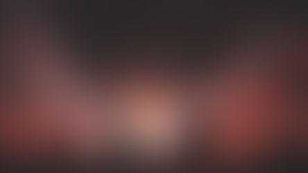 Silhouettes of people dancing at a Linkin Park concert with strobe lighting and a LED box hanging above the crowd