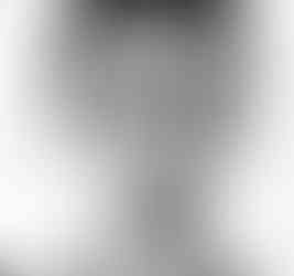 A black-and-white photo of a young man smiling at the camera