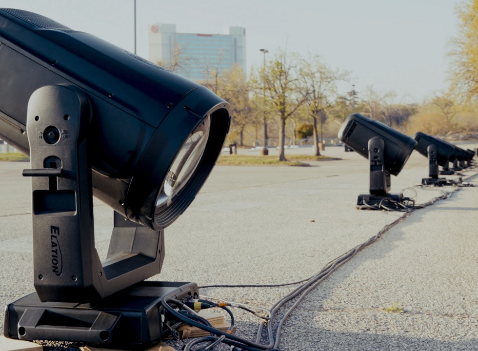 A row of professional lights set up on the concrete outside