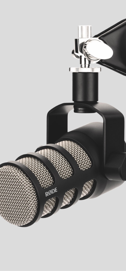 Black RØDE microphone on a stand against a gray background.