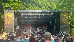 Iron Fest Open Air festival with a metal band standing on a stage with a large audience in front