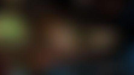 A dimly-lit restaurant with tables and chairs