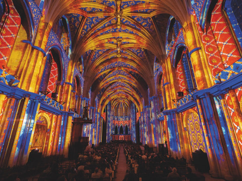 Yellow and blue projection on the roof of a cathedral