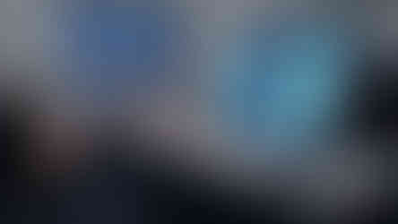 A woman using a computer set up on a high table