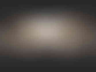 A faded image of a large crowd at a concert with a circle of LED screens hanging above them