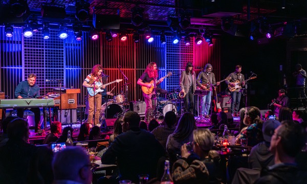 A group of people playing instruments on a stage