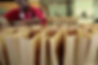 A man packaging something in brown paper bags