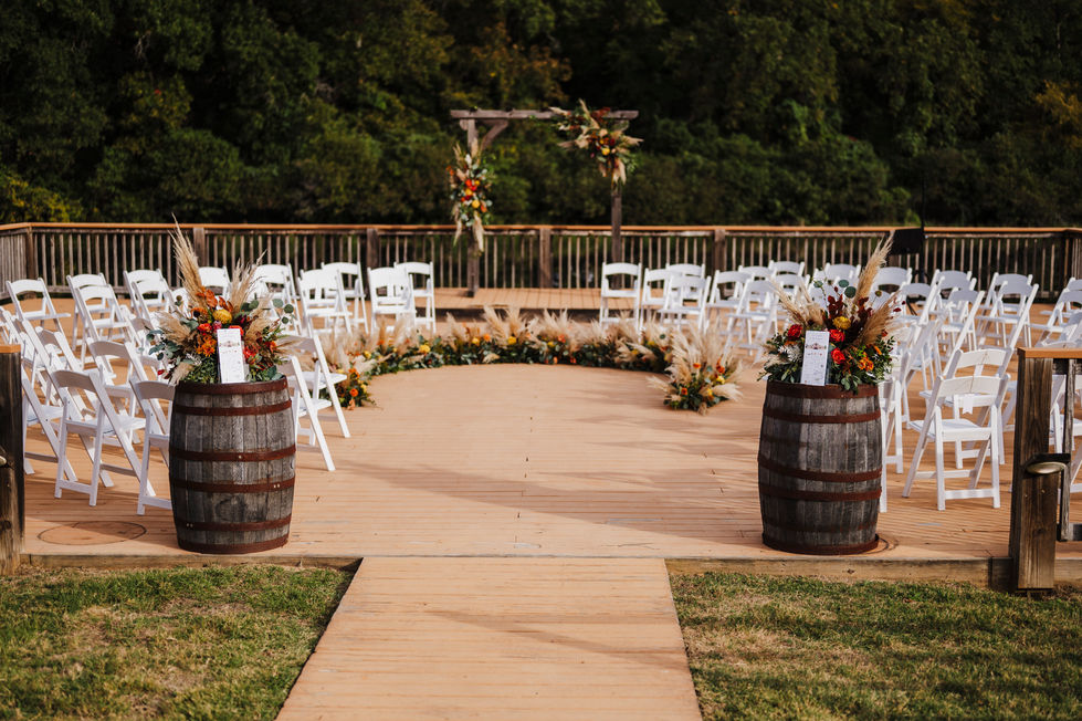View down the aisle toward the ceremony arch and chairs