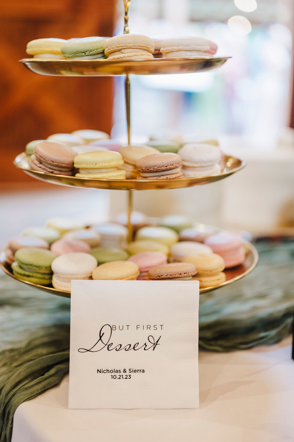 Macaron tower with a printed dessert sign on the table