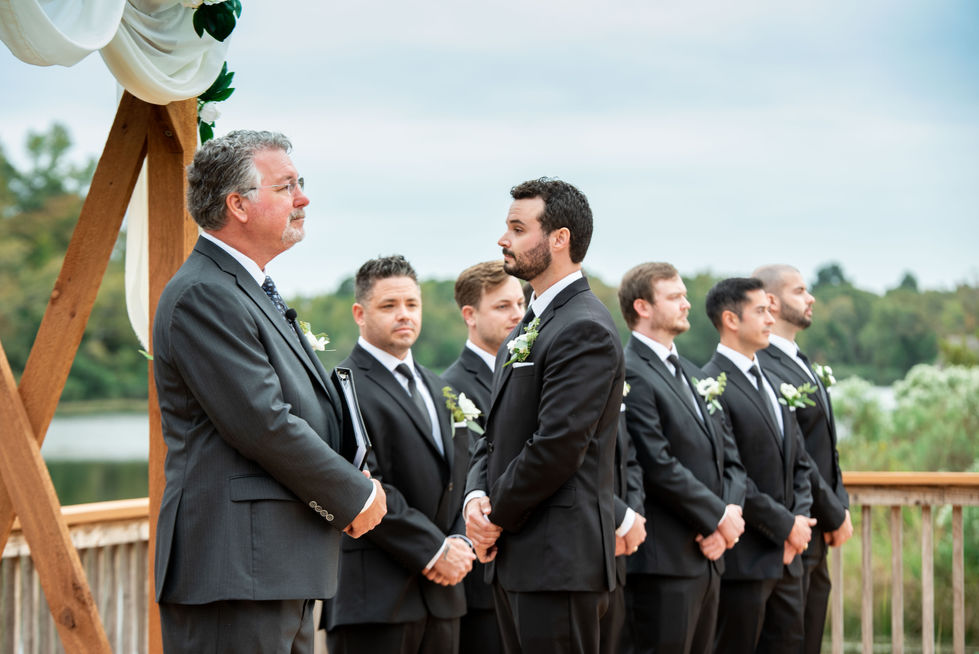 Groom and groomsmen lined up at the altar with the officiant