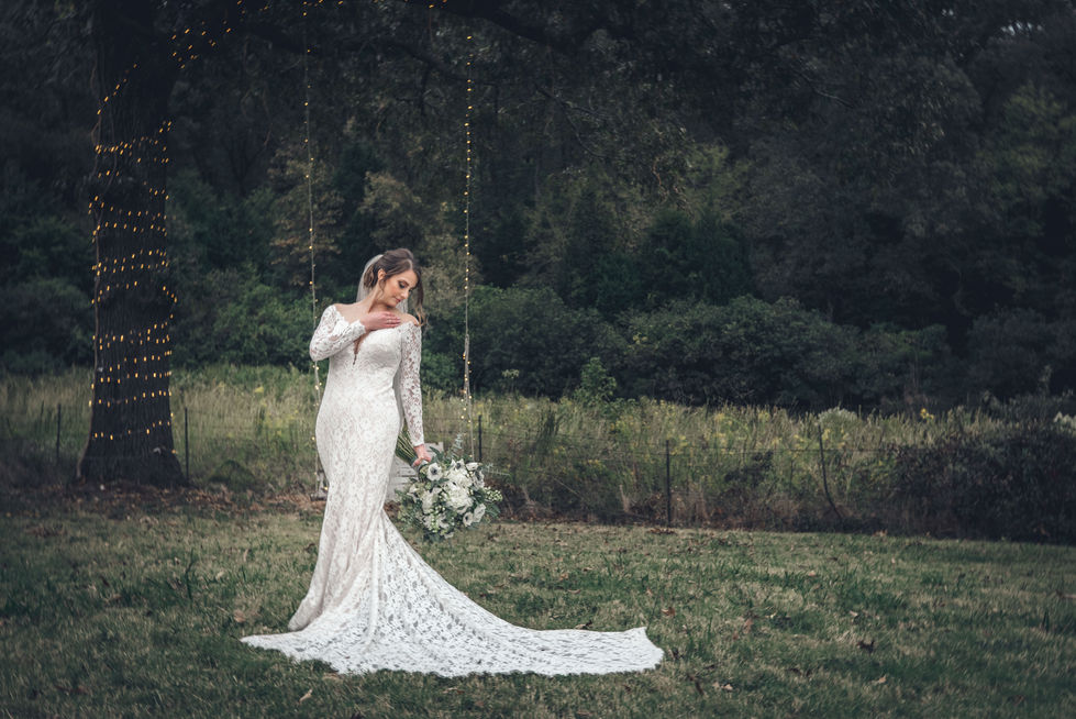Bride twirling in her wedding gown in an open field