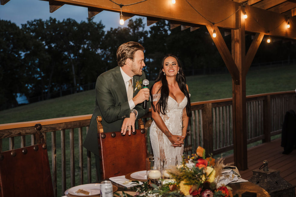 Groom giving a toast at the reception table