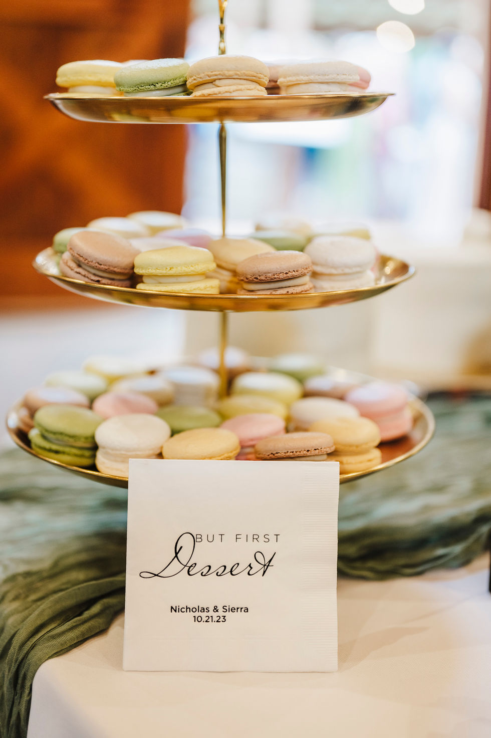 Tiered stand of macarons with a dessert sign