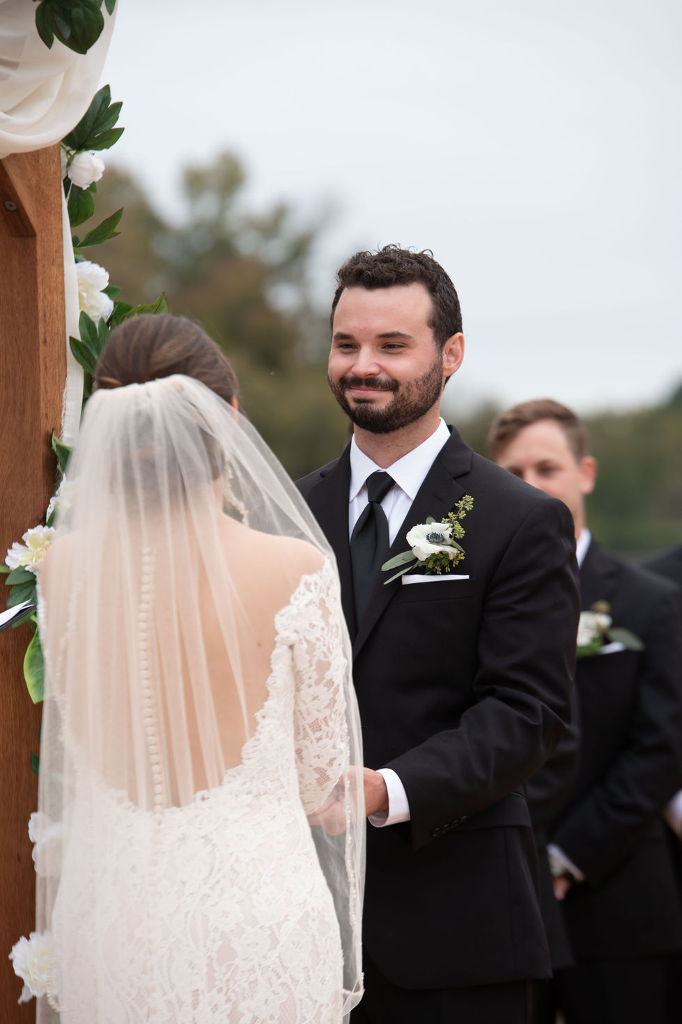 Groom smiling at the bride during the ceremony