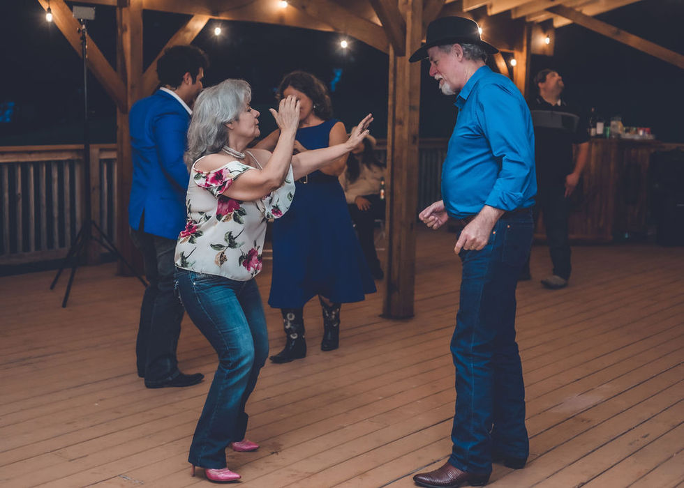 Guests dancing together on the reception dance floor