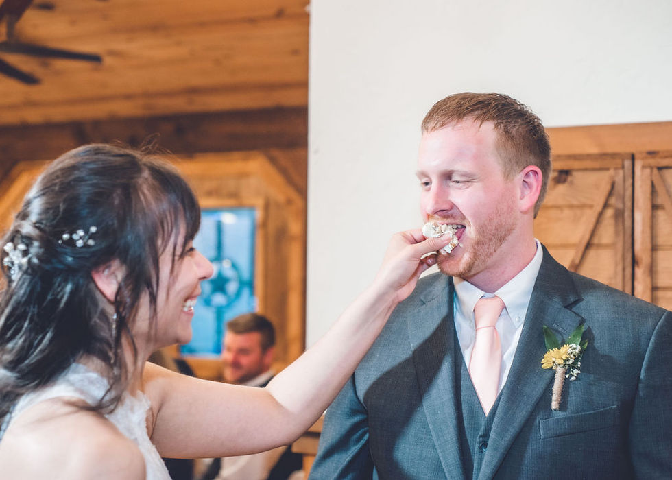 Bride feeding wedding cake to the groom