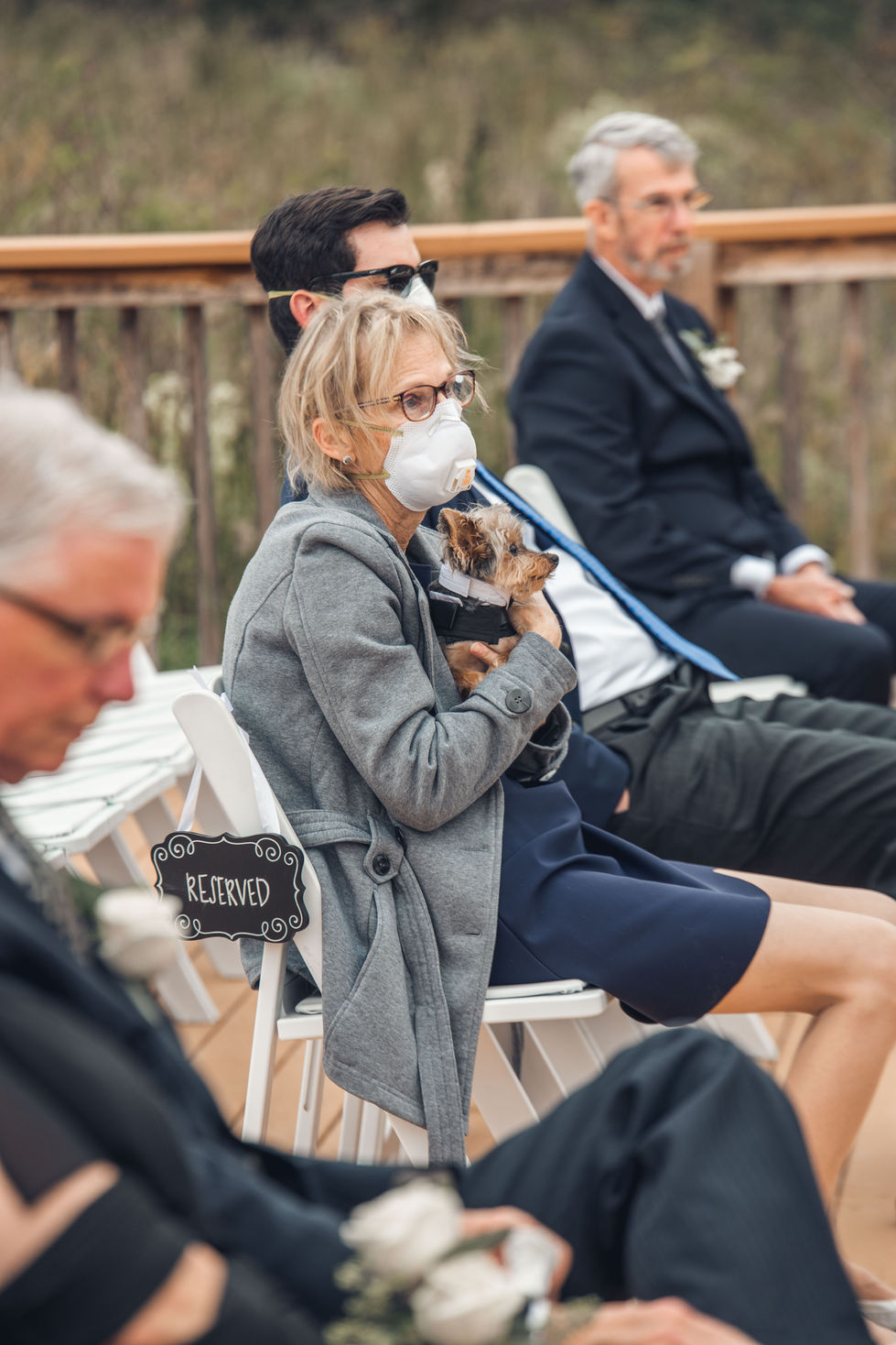 Wedding guest in sunglasses filming the ceremony on her phone