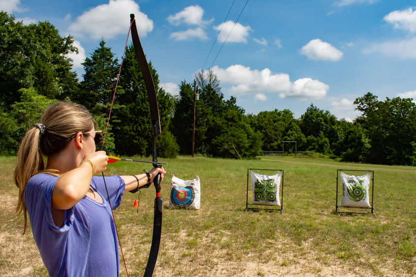 Bow hunter in ground blind overlooking creek and ravine at Cedar Cove Ranch
