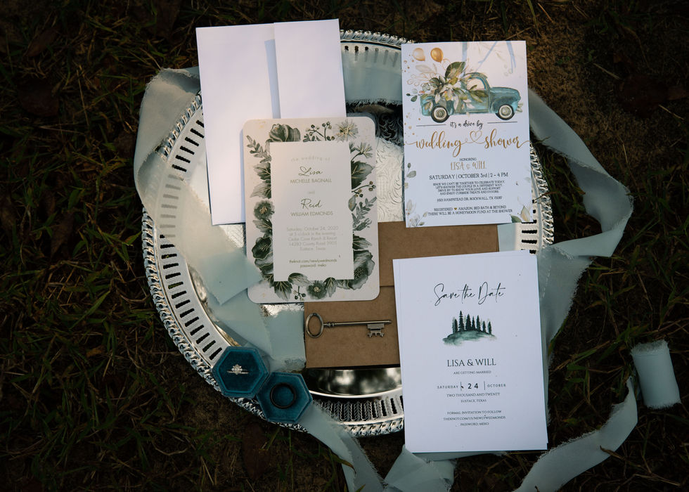 Wedding invitation suite with floral illustrations displayed on a silver charger