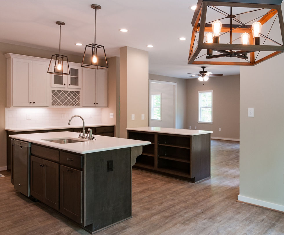 Kitchen with stained lower cabinets and white wall cabinets, vinyl wood-look floors and black accent
